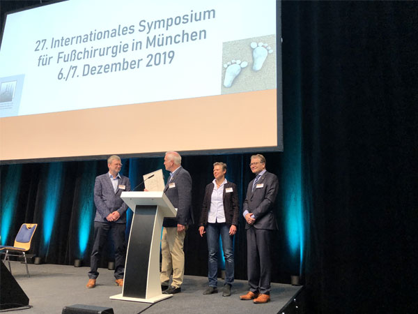 Dr. Randt übergibt gemeinsam mit Dr. Röser und Dr. Stinus die Urkunde an Dr. Olms